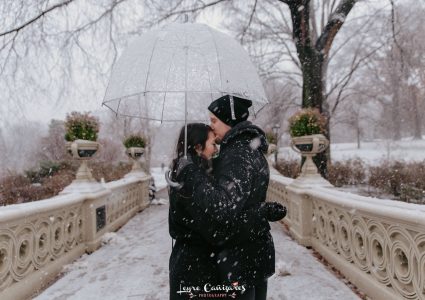 couple photoshoot in bow bridge with snow, central park