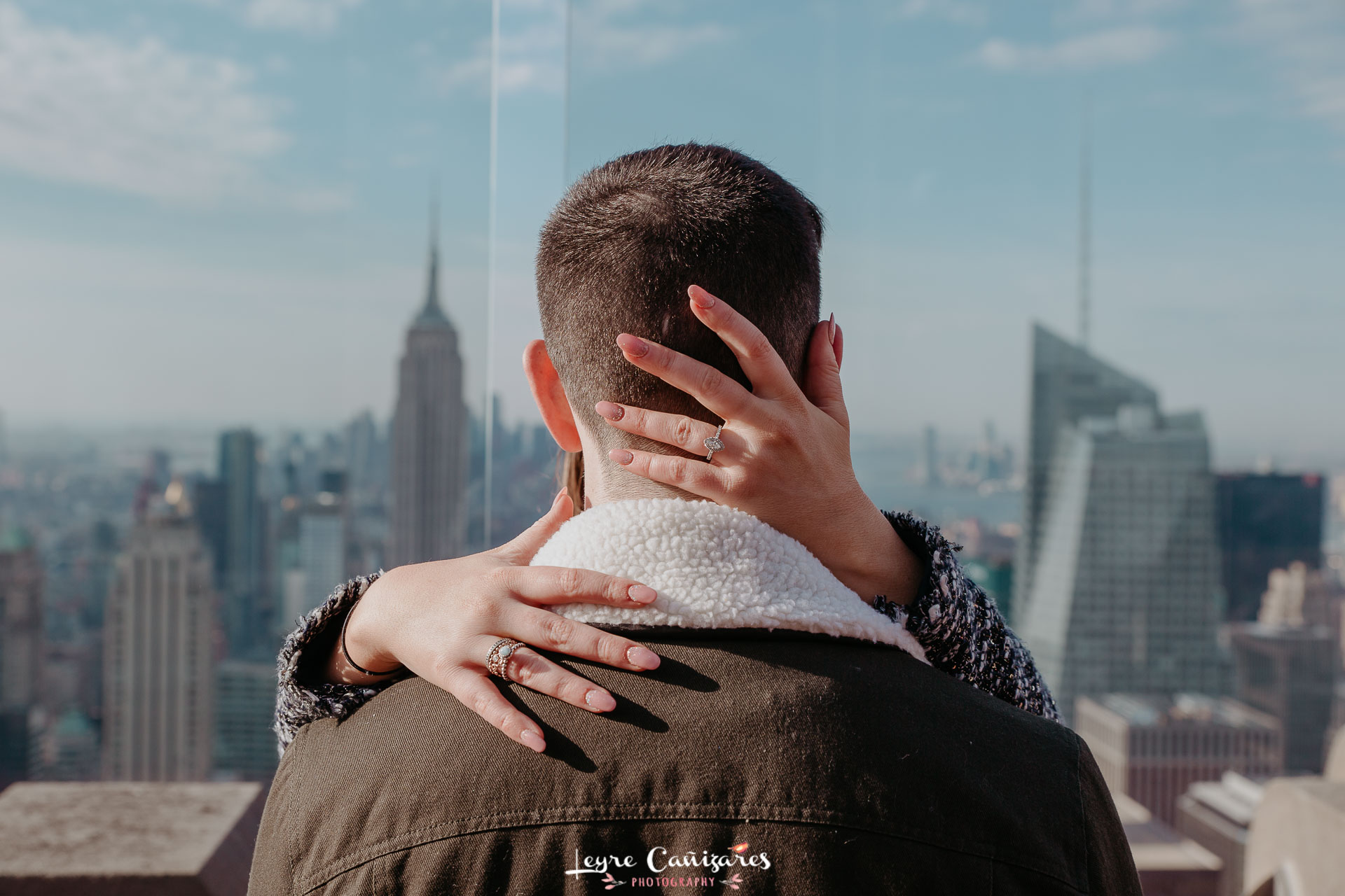 surprise proposal on the top of the rock with a engagement photographer