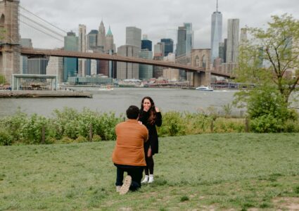 surprise proposal session at dumbo park with manhattan in the background