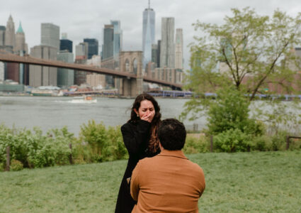 surprise proposal session at dumbo park with manhattan in the background