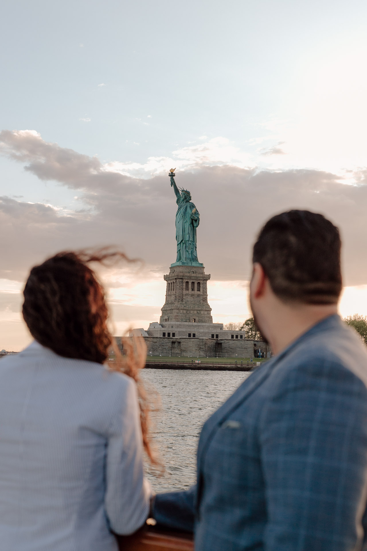 surprise proposal photoshoot on a boat with the liberty statue