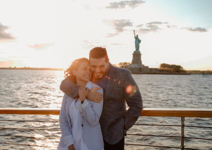 surprise proposal photoshoot on a boat with the liberty statue