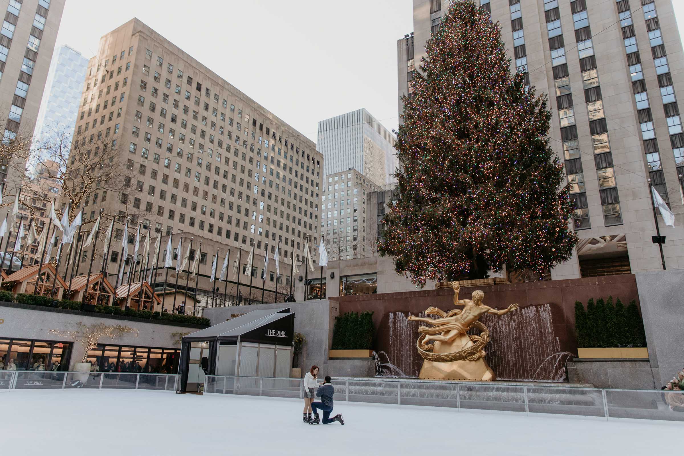 rockefeller center surprise proposal in front of the christimas tree